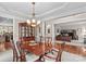 Formal dining room with chandelier adjacent to office and kitchen, ideal for entertaining at 7896 Harbor Master Ct, Denver, NC 28037