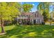 Stately brick home featuring a manicured lawn and covered front porch with white pillars and railing at 7896 Harbor Master Ct, Denver, NC 28037