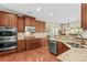Spacious kitchen featuring stainless steel appliances, wooden cabinets, tile backsplash, and hardwood floors at 7896 Harbor Master Ct, Denver, NC 28037
