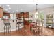 Kitchen and breakfast nook with wooden cabinets, granite countertops, breakfast bar and dining table at 7896 Harbor Master Ct, Denver, NC 28037