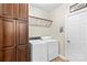 Functional laundry area with washer, dryer, built-in shelving and tiled floor at 7896 Harbor Master Ct, Denver, NC 28037