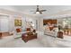 Cozy living room featuring neutral furniture, a large coffee table, and views into the dining and kitchen areas at 7896 Harbor Master Ct, Denver, NC 28037