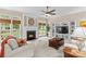 Inviting living room featuring a fireplace, large windows, neutral decor, and a built-in media center at 7896 Harbor Master Ct, Denver, NC 28037