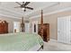 Spacious bedroom featuring a four-poster bed, tray ceiling, and neutral color palette at 7896 Harbor Master Ct, Denver, NC 28037