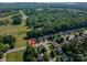 Great aerial view of the home and surrounding neighborhood with mature trees and green lawns at 7905 Sedgebrook E Dr, Stanley, NC 28164