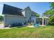 Large backyard with well-maintained lawn, mature trees, and a charming pergola-covered patio area at 7905 Sedgebrook E Dr, Stanley, NC 28164