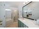 Bright bathroom boasts double sinks, garden tub, glass enclosed shower, and tile flooring at 7905 Sedgebrook E Dr, Stanley, NC 28164