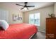 Cozy bedroom featuring neutral tones, a ceiling fan, and bright natural light at 7905 Sedgebrook E Dr, Stanley, NC 28164