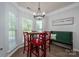 Inviting eat-in kitchen features a table with red chairs and bench seating near the window at 7905 Sedgebrook E Dr, Stanley, NC 28164