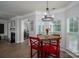 Cozy breakfast nook with a rustic wooden table, bright red chairs, and lots of natural light at 7905 Sedgebrook E Dr, Stanley, NC 28164
