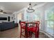 Bright breakfast nook with large windows, wood-style floors, and modern light fixture at 7905 Sedgebrook E Dr, Stanley, NC 28164