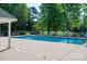 Community pool with plenty of seating and umbrellas on a sunny day at 7905 Sedgebrook E Dr, Stanley, NC 28164