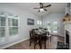 Bright dining room with hardwood floors, large windows, and access to the backyard at 7905 Sedgebrook E Dr, Stanley, NC 28164