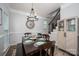 Dining room with dark wood table, matching chairs, cabinet, modern lighting, and staircase at 7905 Sedgebrook E Dr, Stanley, NC 28164