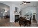 Dining area featuring a fireplace, hardwood floors, and adjacent living room at 7905 Sedgebrook E Dr, Stanley, NC 28164