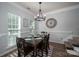 Formal dining room features a dark wood table, six chairs, and a modern chandelier above at 7905 Sedgebrook E Dr, Stanley, NC 28164