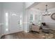 Inviting entryway with wood floors, decorative glass door, and a cozy seating area with chairs and an ottoman at 7905 Sedgebrook E Dr, Stanley, NC 28164