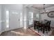 The foyer features a decorative glass front door that complements the dining area and lighting at 7905 Sedgebrook E Dr, Stanley, NC 28164