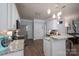 Bright kitchen features stainless steel appliances, granite countertops, and modern pendant lighting at 7905 Sedgebrook E Dr, Stanley, NC 28164