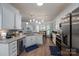 Modern kitchen with stainless steel appliances, granite countertops, and a breakfast bar for casual dining at 7905 Sedgebrook E Dr, Stanley, NC 28164
