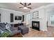 Comfortable living room featuring a fireplace, television, hardwood floors, and crown molding at 7905 Sedgebrook E Dr, Stanley, NC 28164
