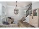 Cozy living room seating arrangement near a staircase featuring an accent wall and hardwood floors at 7905 Sedgebrook E Dr, Stanley, NC 28164