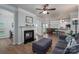 Open concept living room with fireplace, and kitchen featuring hardwood floors and modern finishes at 7905 Sedgebrook E Dr, Stanley, NC 28164