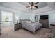 Spacious main bedroom features a large bed, ceiling fan, and an ensuite bathroom at 7905 Sedgebrook E Dr, Stanley, NC 28164