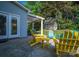 Inviting patio with yellow Adirondack chairs and a pergola, perfect for outdoor living at 7905 Sedgebrook E Dr, Stanley, NC 28164