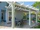 Relaxing backyard covered pergola with an outdoor dining area and stamped concrete at 7905 Sedgebrook E Dr, Stanley, NC 28164