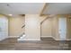 Spacious basement featuring updated flooring and a staircase, ready for customization and finishing at 8835 Hunter Ridge Dr, Charlotte, NC 28226