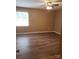 Bright bedroom boasts new floors, a ceiling fan, and a sun-filled window at 8835 Hunter Ridge Dr, Charlotte, NC 28226