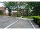 This home features a parking, exterior brick detail, a green door, and shutters at 8835 Hunter Ridge Dr, Charlotte, NC 28226