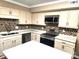 Well-equipped kitchen featuring stainless steel appliances and mosaic backsplash at 8835 Hunter Ridge Dr, Charlotte, NC 28226
