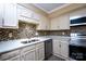 Well lit kitchen featuring stainless steel appliances, mosaic backsplash, and ample countertop space at 8835 Hunter Ridge Dr, Charlotte, NC 28226