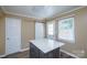 Bright kitchen island featuring multiple doors and a view of pantry and entry at 8835 Hunter Ridge Dr, Charlotte, NC 28226