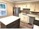 Modern kitchen boasts stainless steel appliances and a central island at 8835 Hunter Ridge Dr, Charlotte, NC 28226