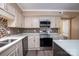 Charming kitchen features stainless steel appliances, mosaic backsplash, and light colored cabinetry at 8835 Hunter Ridge Dr, Charlotte, NC 28226