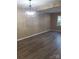 Bright living room with modern lighting fixture and wood-look flooring at 8835 Hunter Ridge Dr, Charlotte, NC 28226