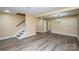 Bright living room with modern flooring, stairs, neutral walls, and ample space for flexible arrangement at 8835 Hunter Ridge Dr, Charlotte, NC 28226