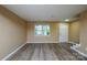 Inviting living room features new flooring, fresh paint, and a bright window overlooking the landscaped front yard at 8835 Hunter Ridge Dr, Charlotte, NC 28226