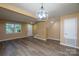 Spacious living room features updated floors, neutral paint, and a chandelier, ideal for entertaining and relaxing at 8835 Hunter Ridge Dr, Charlotte, NC 28226