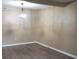 Open living room featuring modern light fixture and wood-look flooring at 8835 Hunter Ridge Dr, Charlotte, NC 28226