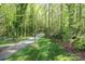 Paver driveway winding through a lush, wooded landscape leading to the property at 8903 New Town Rd, Waxhaw, NC 28173
