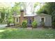 Charming home featuring a brick chimney, blue front door, and beautifully landscaped front yard at 8903 New Town Rd, Waxhaw, NC 28173