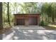 Detached garage with two bays, shingle siding, and a paved parking area at 8903 New Town Rd, Waxhaw, NC 28173