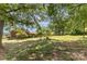 Private backyard with mature trees and well-maintained lawn offering a peaceful retreat at 910 E Center Ave, Mooresville, NC 28115