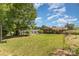 Expansive backyard features lush lawn and mature trees, creating a serene and private outdoor space at 910 E Center Ave, Mooresville, NC 28115