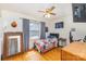 Cozy bedroom with hardwood floors, a ceiling fan, and a window with natural light at 910 E Center Ave, Mooresville, NC 28115