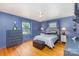 Comfortable bedroom with hardwood floors, neutral walls, and a ceiling fan at 910 E Center Ave, Mooresville, NC 28115